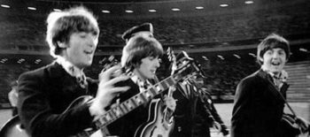 os beatles caminhando com seus instrumentos musicais