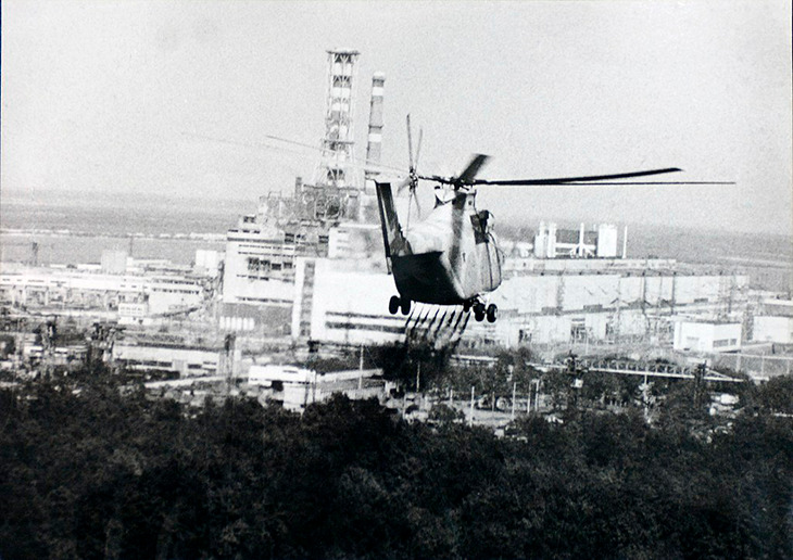 Um helicóptero pulveriza um líquido de descontaminação perto do reator de Chernobyl